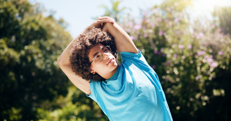 Stretching, fitness and man in nature for workout with health, wellness and body training. Sport, outdoor and male athlete with warm up exercise for running with cardio activity in park for challengeの写真素材