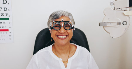 Client, portrait or mature woman in eye test at optometry clinic for eyewear, treatment or sight wellness. Trial glasses, .face or smile in assessment for diagnosis, exam or consultation in Brazilの写真素材
