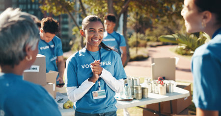 Happiness, volunteer woman and charity as group for community service, project or nonprofit initiative. People, teamwork and together as collaboration, outdoor and program with help, donations or NGOの写真素材