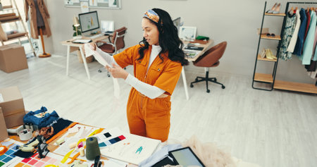 Decision, creative and fabric with fashion designer woman in textile workshop for material choice. Clothing industry, table and texture with style director in office for manufacturing or productionの写真素材