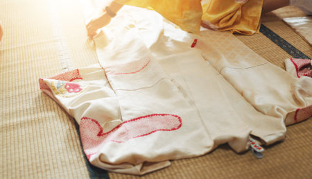 Fashion designer, tailoring and hands with measuring fabric for kimono garment and manufacturing process in workshop. Seamstress, person and dress pattern of textile design at japanese small businessの写真素材