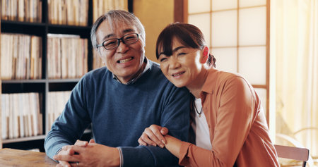 Love, retirement and portrait with senior couple in home together for bonding, relationship or romance. Happy, hug or smile with old Japanese man and woman in apartment to relax for wellnessの写真素材