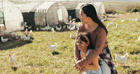 Family, mother and girl on chicken farm for holiday, adventure and vacation in countryside. Agriculture, sustainable farming and mom with child and livestock for poultry, agro business and produceの写真素材