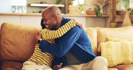 Hugging, love or smile with dad and son on sofa in living room of home together for development. Black family, bonding or happy with boy child and single parent man embracing in apartment for supportの写真素材