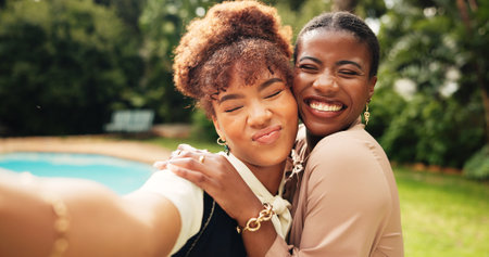 Happy women, love and hug with selfie for memory, picture or photography together in nature. Female people, friends or smile with embrace or friendship for capture moment, care or outdoor bondingの写真素材