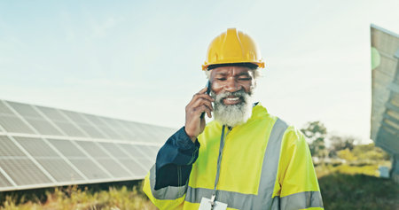 Engineer, solar energy and man with phone call outdoor for photovoltaic inspection and feedback on power saving check. Mature technician, talking or network integration for quality assurance on fieldの写真素材