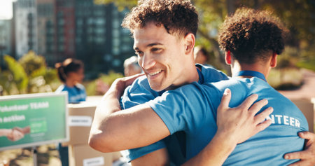 Hug, smile and volunteers for charity, men or collaboration of friends, outdoor activity and support. Team, park and happy people with project for nonprofit, helping or proud of community serviceの写真素材