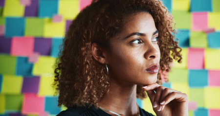 Research, thinking and business woman with idea for creative project, company insights or brainstorming. Professional, wall background and person for development, sticky notes and planning at startupの写真素材