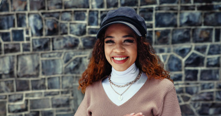 Portrait, fashion and woman in city, smile and confidence with pride, trendy clothes and wall...