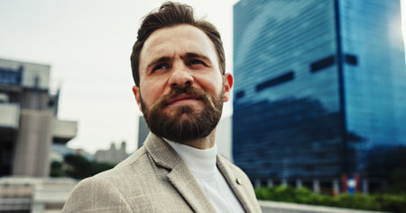 Idea, thinking and businessman in city for vision, insight and mindset for solution. Future, urban professional and planning outdoor for real estate development, decision and investment opportunityの写真素材