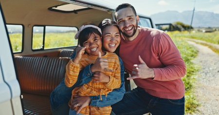 Portrait, road trip and van with thumbs up, family and love for journey and countryside travel. Happy, hug and child bonding for adventure, holiday break and vacation together with car, mom or dadの写真素材