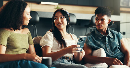 House, cellphone and friends on sofa, typing and network with weekend break, smile and relax. People, apartment and women with man, smartphone and talking with connection, comfort or bonding togetherの写真素材