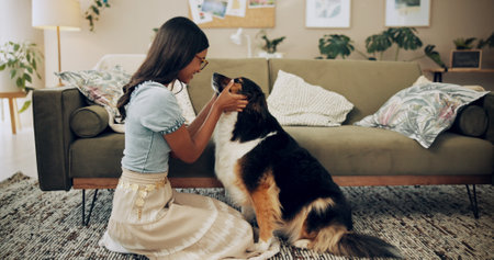 Home, love and woman with dog, smile and owner with loyalty for companion, lounge and care in apartment. Living room, chilling and bonding with pet, person and comfortable with animal in houseの写真素材