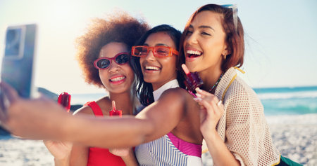 Group, selfie and girl with ice cream at beach, summer or excited with diversity for post on web. Women, happy and popsicle for photography, hug or profile picture on social media for vacation by seaの写真素材