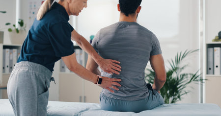 Back massage, physical therapy and patient at consultation for problem, inflammation or muscle...