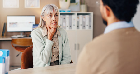 Mature woman, doctor and sore throat in consultation for medical services or professional opinion. People, symptoms and patient in clinic for appointment, checkup and healthcare with illness or virusの写真素材