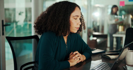 Business, woman and laptop in office with reading market research for social media campaign and brand awareness. Creative agency, marketing influencer or online for planning product promotion at deskの写真素材