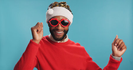 Christmas, dance and portrait of happy black man in Santa hat for festive celebration or event....