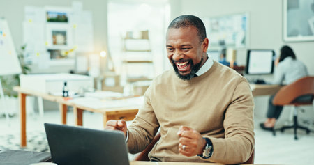 Happy, black man and laptop with winning for good news, promotion or celebration at office. Excited, businessman or employee with smile or fist pump on computer for amazing offer or deal at workplaceの写真素材