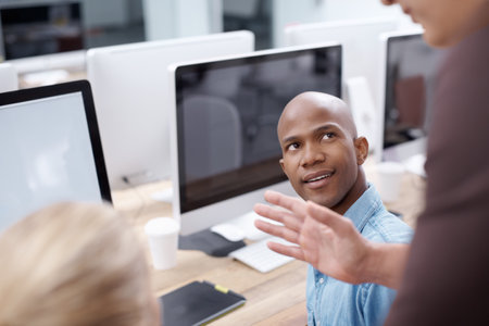 Computer, training and web development with business people in creative workplace for meeting. Coaching, direction and hand with man and woman designer ot programmer group at desk in office togetherの写真素材