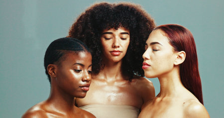 Women, diversity and serious for skincare in studio background for inclusive beauty. Natural, people and eyes closed with glow for power or empowerment with body care, skin treatment and supportの写真素材
