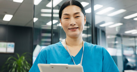 Nurse, clipboard and portrait of Japanese woman with smile, document and medical checklist in hospital. Surgeon, nursing and paperwork for health, wellness and clinic care with professional at jobの写真素材
