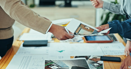 Architects, hands and creative meeting with documents, planning and agency for design partnership. Business people, tablet and engineering for blueprint, brainstorming or problem solving for startupの写真素材