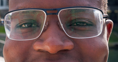 Optometry, glasses and eyes of black man for vision, health and wellness with prescription. Spectacles, portrait and African male person with lens and frame for optical care or eyesight improvement.の写真素材