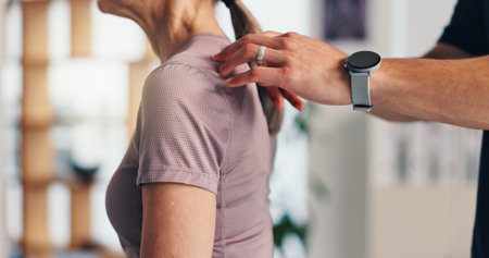 Shoulder pain, physiotherapy and consulting with old woman in clinic for healthcare, osteoarthritis and symptoms. Medical advice, physical therapy and helping with closeup of patient for chiropractorの写真素材