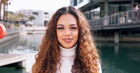 Travel, portrait and woman on vacation, smile and happy for tourism, adventure and scenery of lake. Outdoor, tourist and person on holiday, water and fresh air for traveller, relax and peace in USAの写真素材