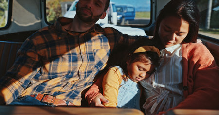 Family, relax and transport on road for travel, long distance journey and child tired in city. Man, woman and girl sleeping in shuttle bus for roadtrip, summer vacation and holiday in Puerto Ricoの写真素材