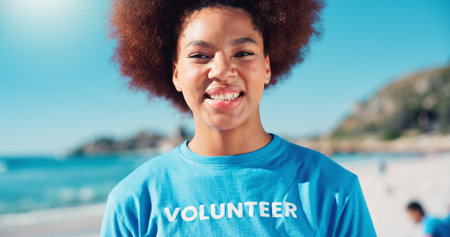 Volunteer, happy and portrait of African woman on beach for cleaning dirt, plastic and litter for ocean. Community service, charity and person for environmental care, recycling and climate changeの写真素材
