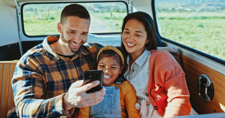 Road trip, selfie and smile of family in van together for outdoor holiday, travel or vacation. Mom,...