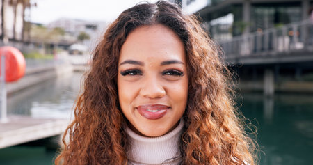 Smile, pride and portrait of woman in city in Brazil for happiness, carefree and confidence. Travel, adventure and urban outdoors with face of female person for weekend, break and positive attitudeの写真素材