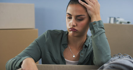 Moving, woman and frustrated with packing box for eviction, home repossession and stress for property debt. Person, relocation and anxiety with mortgage payment fail, mistake and risk of house lossの写真素材