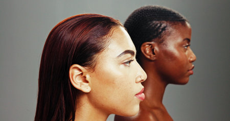 Studio, profile and skincare for women, shine and treatment for glow, confident and cosmetics for antiaging. Grey background, inclusion and dermatology for exfoliation of skin, friends and peopleの写真素材