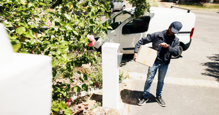 Man, delivery or checking time with box for package, transport service or online order at home address. Male person, driver or courier guy with wristwatch for schedule shipment or parcel distributionの写真素材