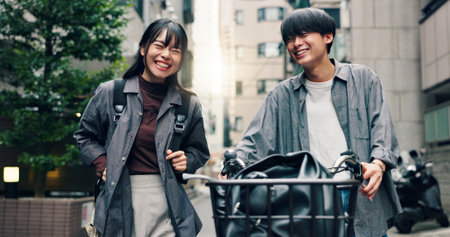 Fashion, laughing and bike with Japanese couple in city for streetwear, genz style and travel. Date, urban and love with asian man and woman walking in outdoors for bonding, casual and cool togetherの写真素材