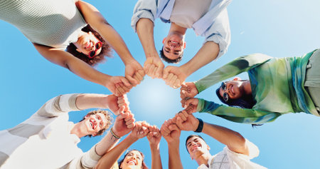 Fist bump, low angle and hands with friends and outdoors for support, community and motivation....
