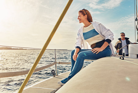 Sea, couple and happy woman on yacht for view, vacation or holiday with summer adventure in Greece. Smile, thinking and female tourist on boat in ocean to relax for tropical weekend trip or travelの写真素材