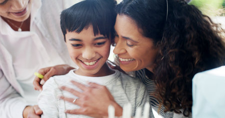 Birthday party, mother and hug child for celebration by home with surprise gathering and bonding together. Happy family, people and embrace for special event wish with care, relationship and supportの写真素材