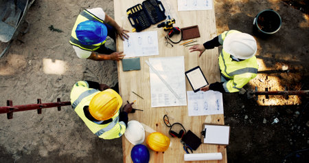 Construction site, business people and planning with tablet for architecture, building and blueprint. Above, engineer team and employees with ideas for industry renovation, infrastructure and meetingの写真素材