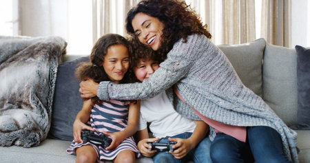 Kids, family home and video game with mom, hug and bonding together in living room. Technology, remote and gaming with sibling, smile and online competition with fun, joy and weekend with loveの写真素材