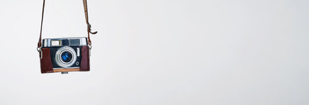 Vintage, camera and banner space in studio isolated on white background mockup for art or design. Retro lens, technology and backdrop for photography, picture or equipment promotion for creative filmの写真素材