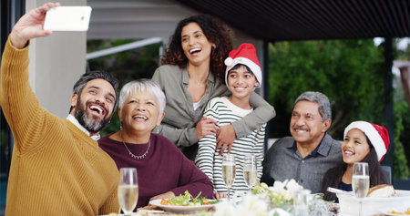 Christmas, happy or family with selfie at lunch by home for holiday memory, profile picture update or bonding. People, parents or grandparents with kids on patio for social event, love or photographyの写真素材