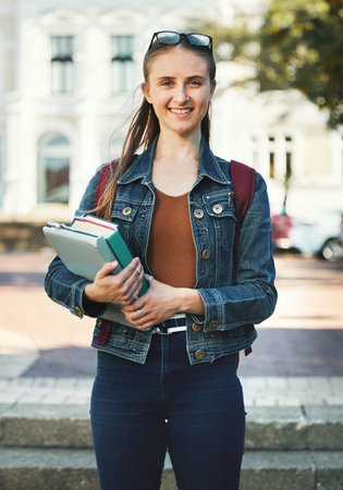 Portrait, woman student or holding books with smile, confident or ready for class studies. Course,...