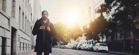 Winter, portrait or man in street walking for work, travel or business commute with confidence. Sunset banner, morning or person in urban city with lens flare, backpack or fashion in London, Englandの写真素材