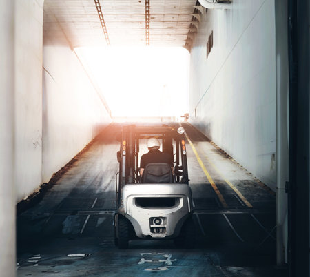 Forklift, shipping and logistics with person in warehouse for supply chain, delivery and export industry. Freight, delivery supervisor and distribution with back of employee for ecommerce and cargoの写真素材