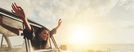 Happy woman, freedom and car window with sunset for road trip, travel or outdoor journey in nature. Banner, female person or tourist with smile in vehicle for adventure or holiday by ocean coastの写真素材