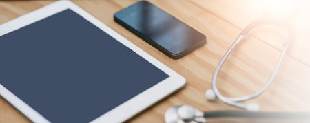 Tablet, stethoscope and phone for telehealth, healthcare and hospital gear in medical clinic,...
